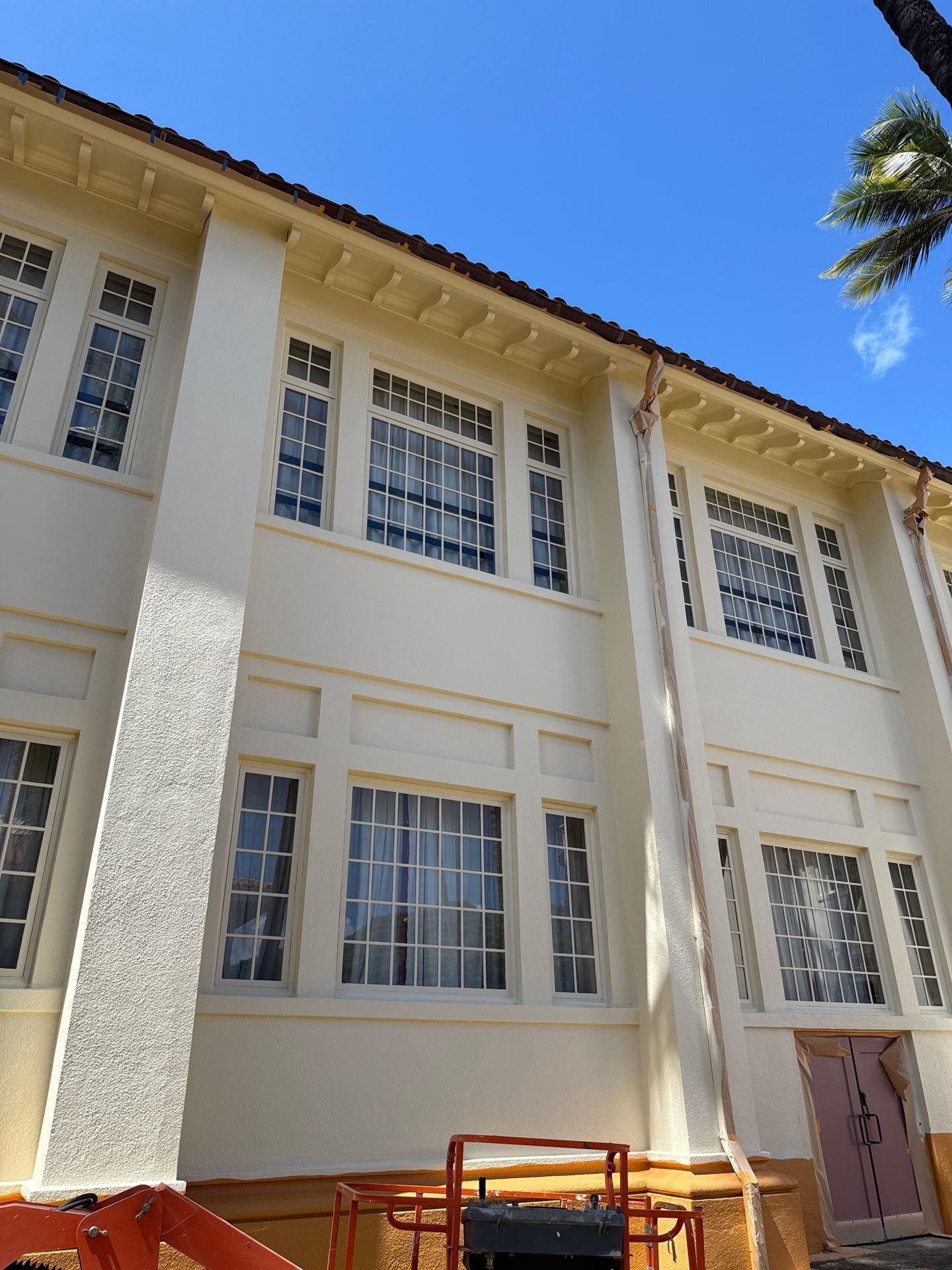 Commercial building exterior repainted in cream with detailed trim in Honolulu, Oahu