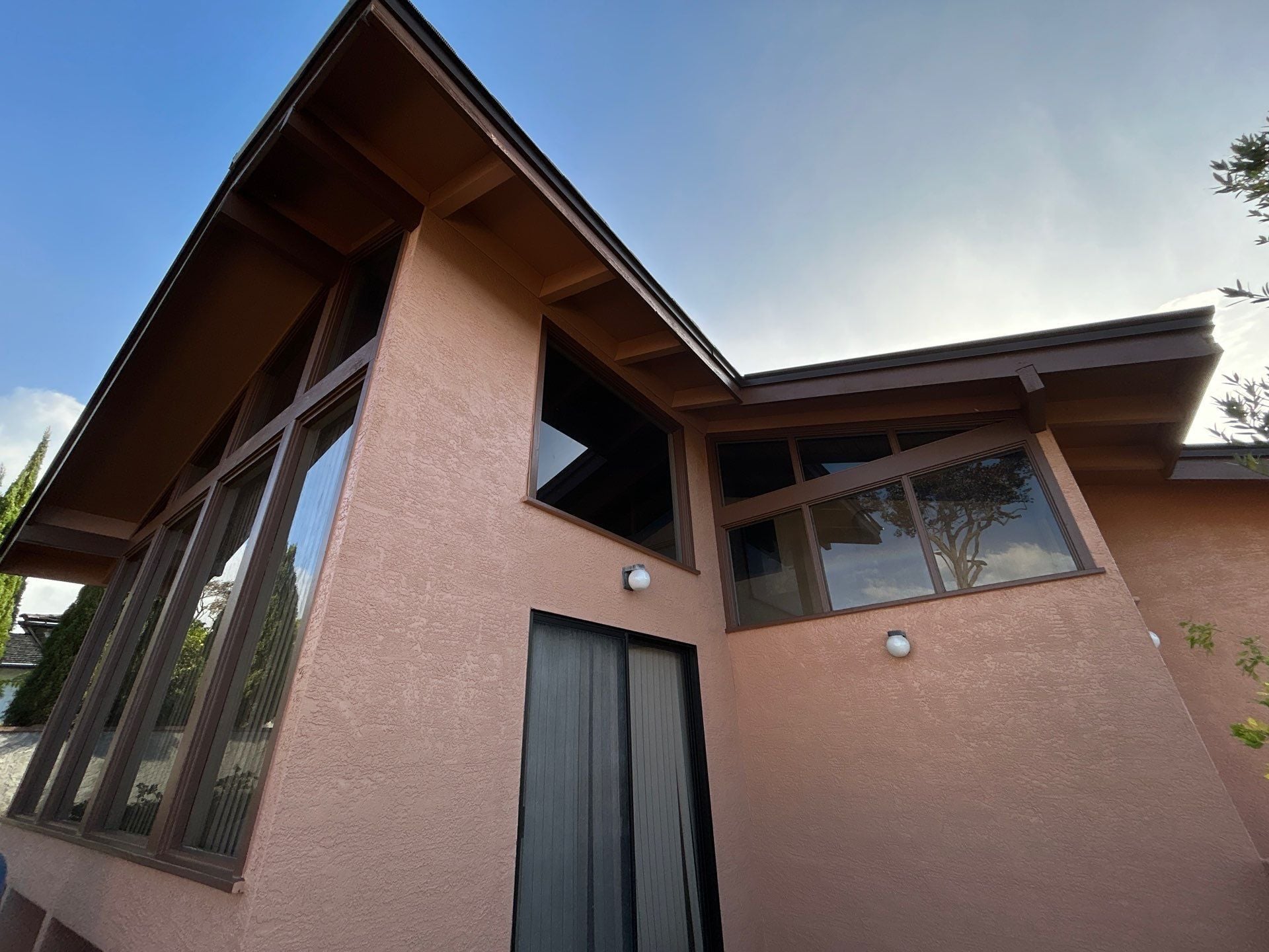 A-frame home with repainted mauve stucco exterior and dark trim in Honolulu, Oahu