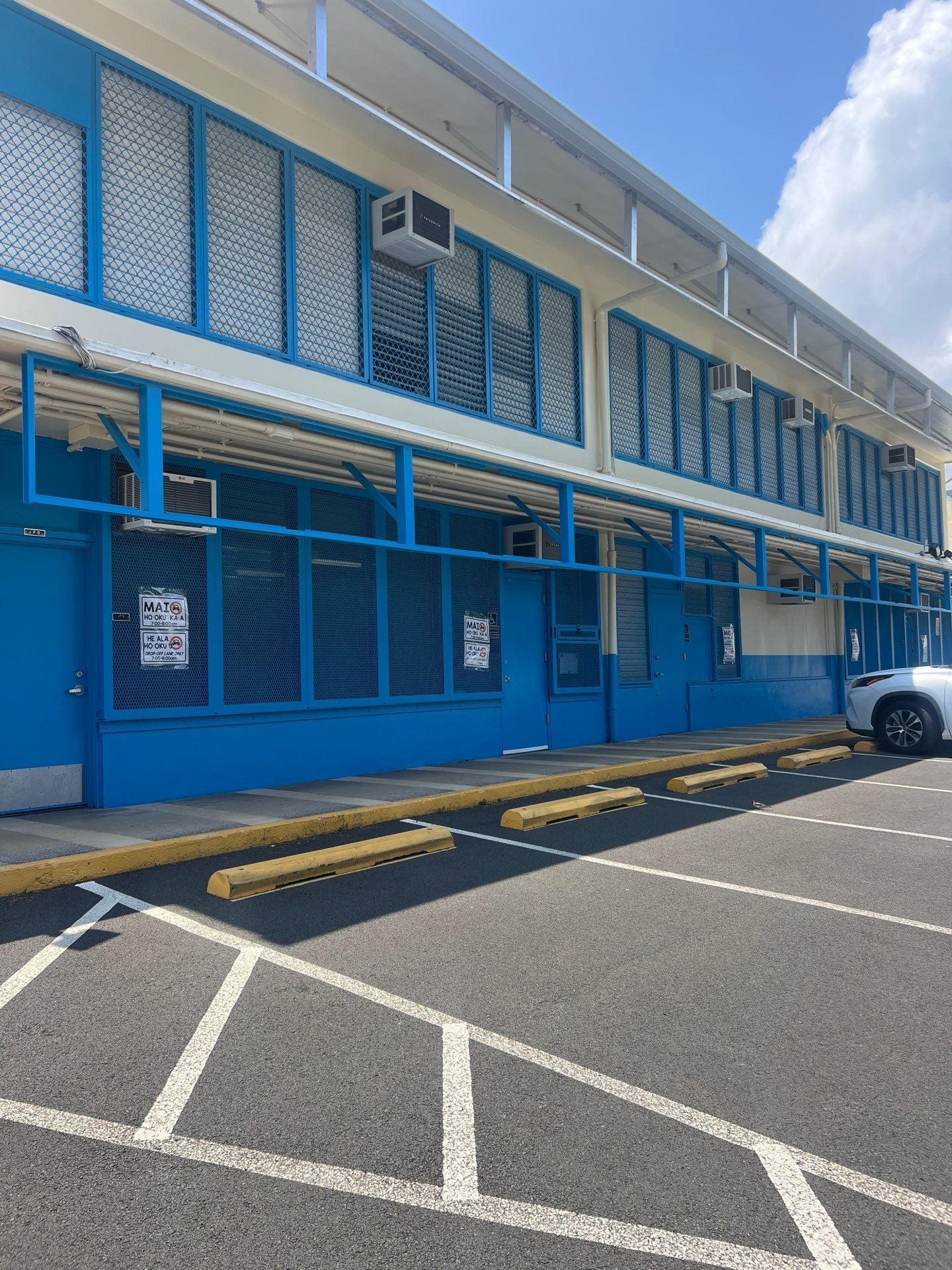 School building exterior repainted in blue with white trim in Honolulu, Oahu